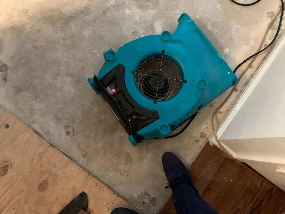Air mover drying subfloor during Commercial Water Damage Restoration in Harvard
